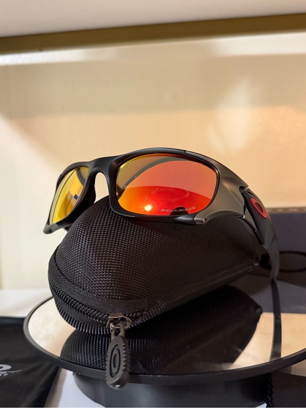 Oakley Matte Black Sunglasses with Red-Orange Mirrored Lenses